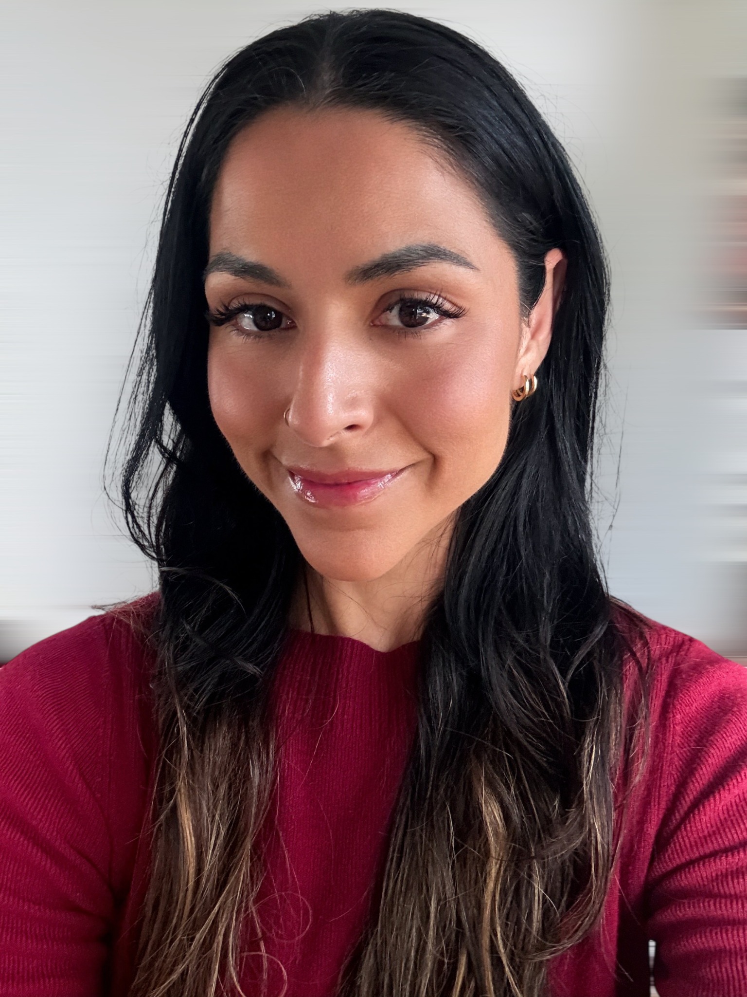 Pamela Socorro, founder of Senja Studio, wearing a red sweater
